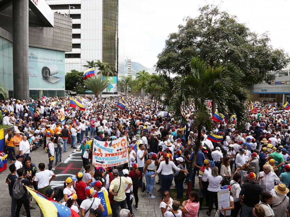 PHOTO: Venezuelans wave flags and hold signs as people gather at PNUD for a demonstration called by opposition leader Juan Guaido during the 208th anniversary of the Venezuelan Independence declaration on July 5, 2019, in Caracas, Venezuela.