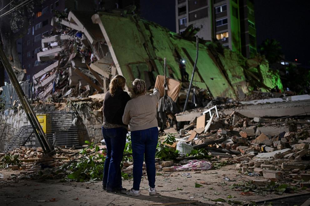 PHOTO: Fanny Nasri waits at the site of a collapsed building as emergency workers search for her son, Antonio Nasri, alongside Noemi Cordoba, who awaits news of her granddaughter, after an earthquake in Caracas, Venezuela, June 25, 2026.