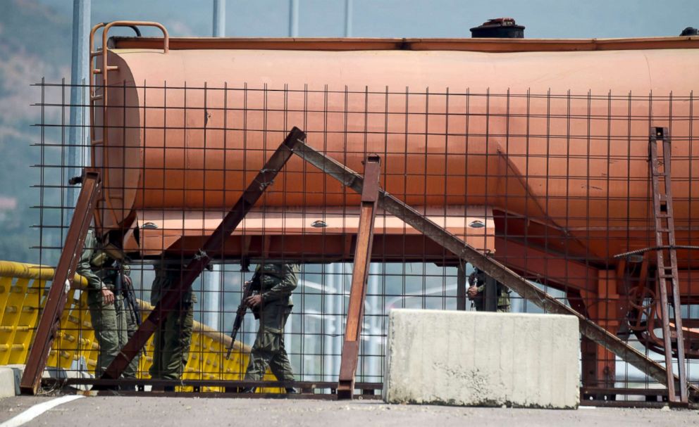 PHOTO: Venezuelan military forces stand guard as they block the Tienditas Bridge, which links Tachira, Venezuela, and Cucuta, Colombia, with containers, Feb. 6, 2019.