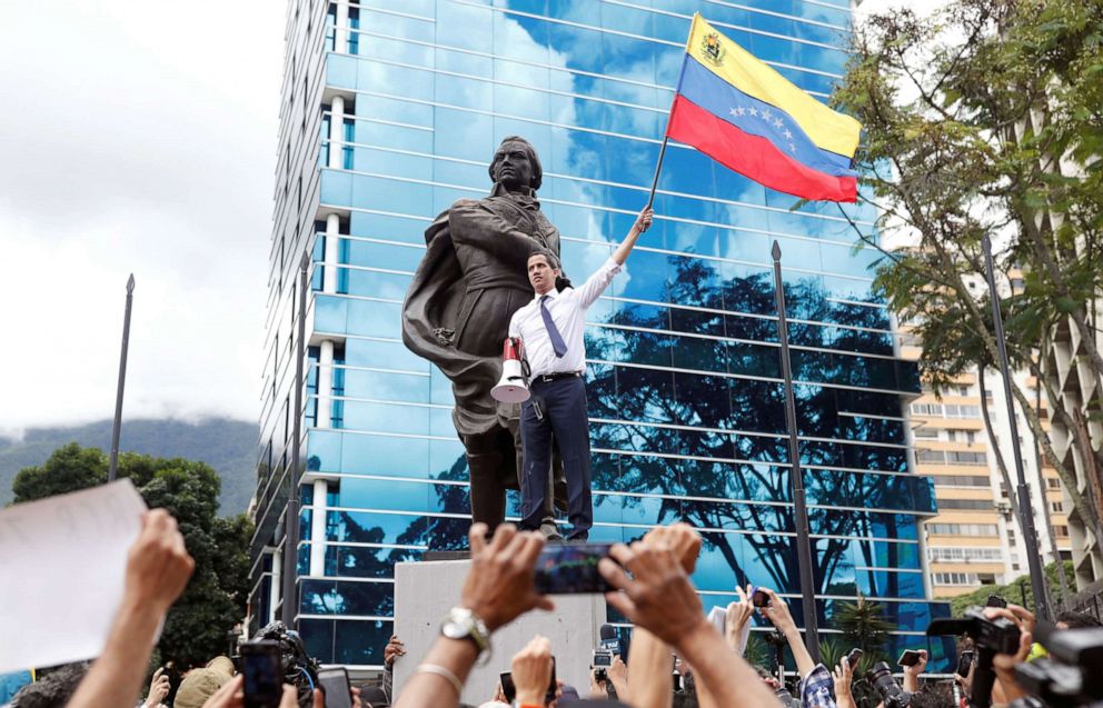 PHOTO: Venezuelan opposition leader Juan Guaido, who many nations have recognised as the country's rightful interim ruler, waves a Venezuelan national flag at a rally in Caracas, Venezuela, July 5, 2019. 