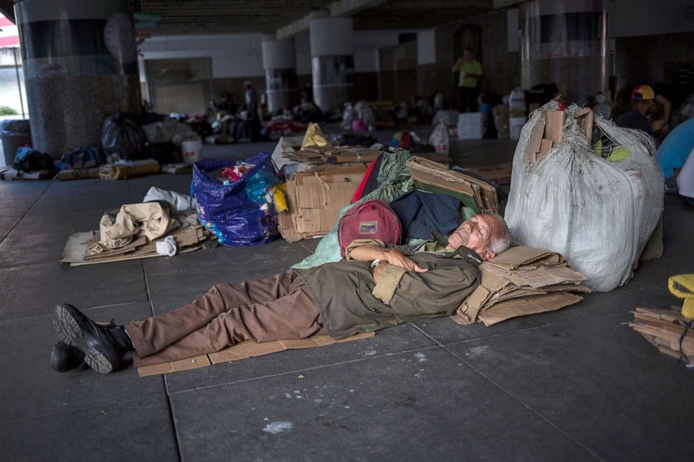 PHOTO: A man sleeps in front of the Venezuela's Central Bank to protest an unpaid retirement bonus for oil workers, in Caracas, Venezuela, July 16, 2019.