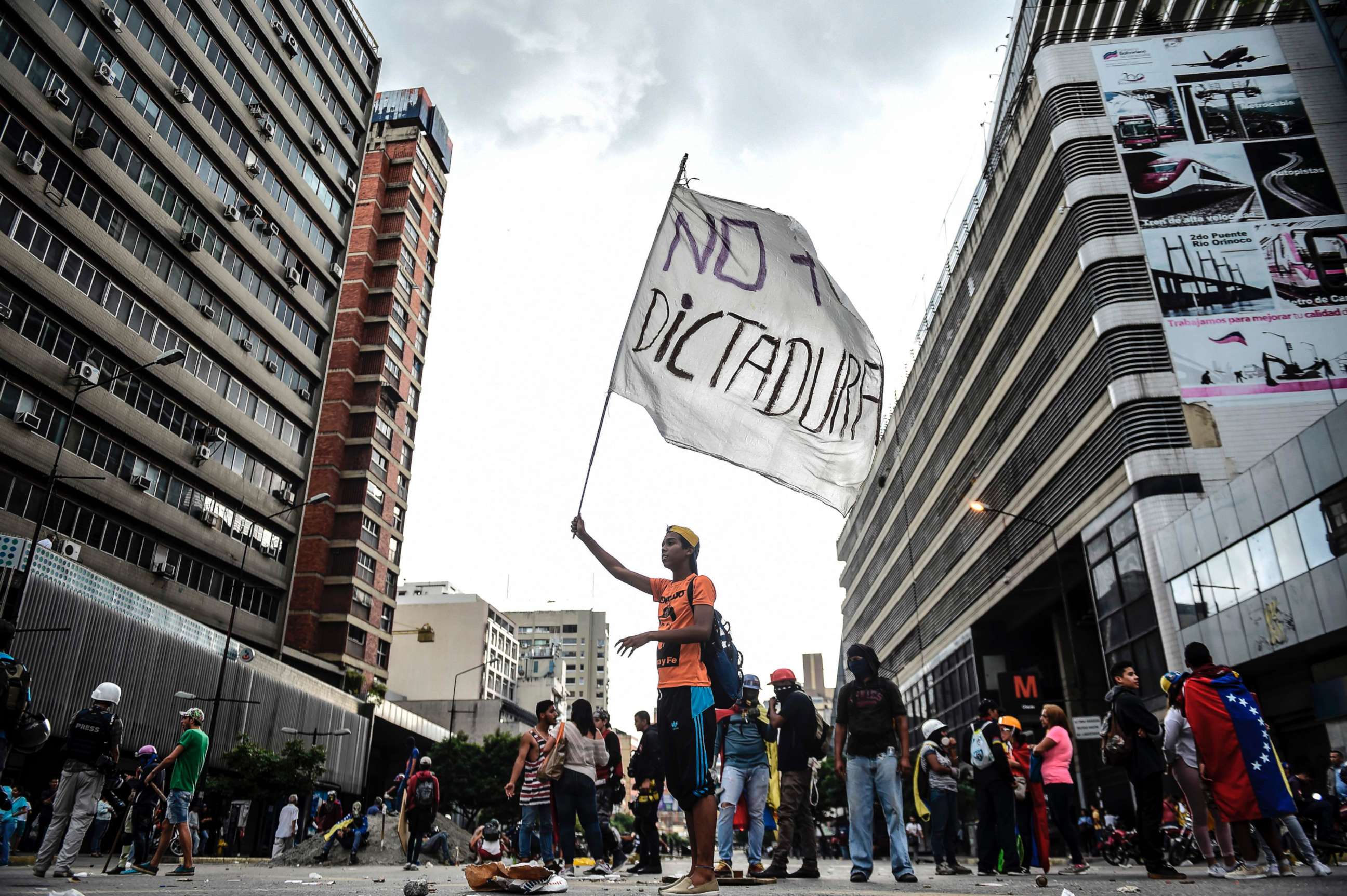 PHOTO: An opposition activist holds a flag reading "No more dictatorship" during a blockade to protest against Venezuelan President Nicolas Maduro in Caracas, July 18, 2017. 