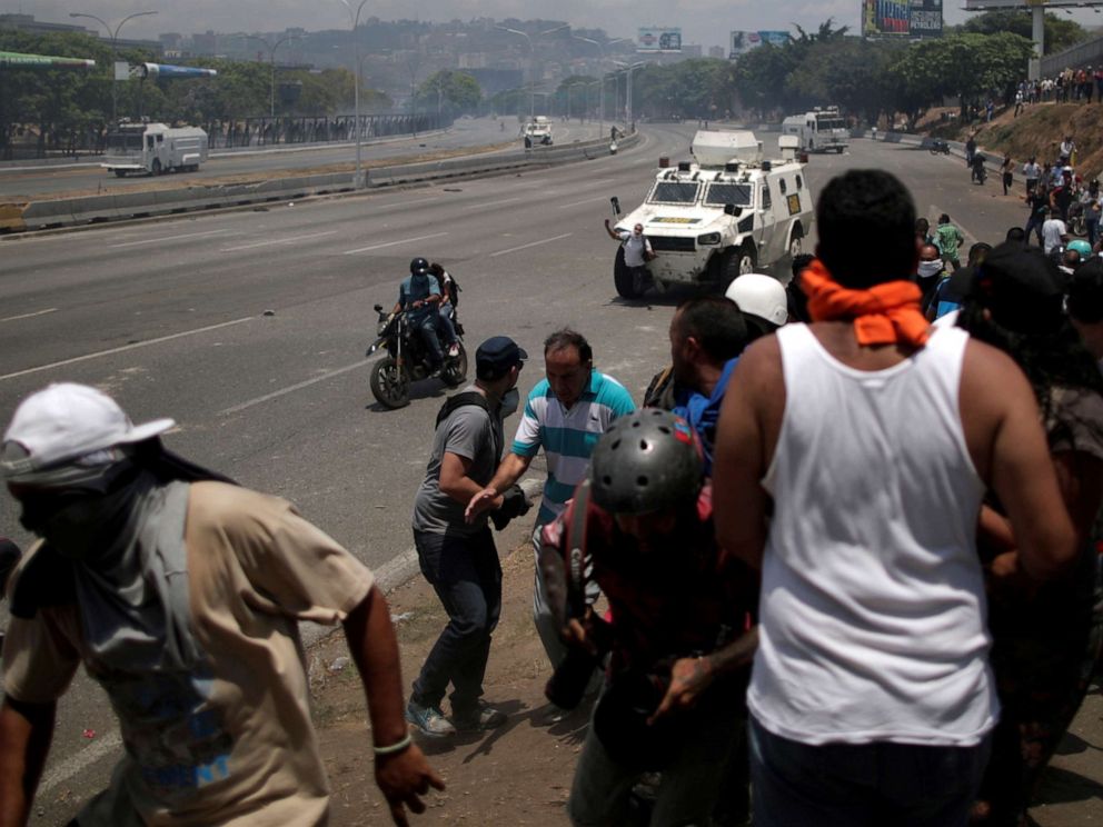 PHOTO: An opposition demonstrator is struck by a Venezuelan National Guard vehicle on a street near the Generalisimo Francisco de Miranda Airbase La Carlota in Caracas, Venezuela, April 30, 2019.