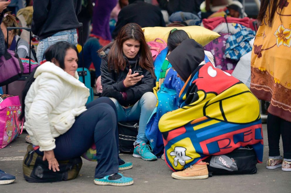 PHOTO: Venezuelan citizens rest at the Rumichaca international bridge after crossing to Ecuador from Colombia, in Tulcan, Ecuador, Aug. 11, 2018.