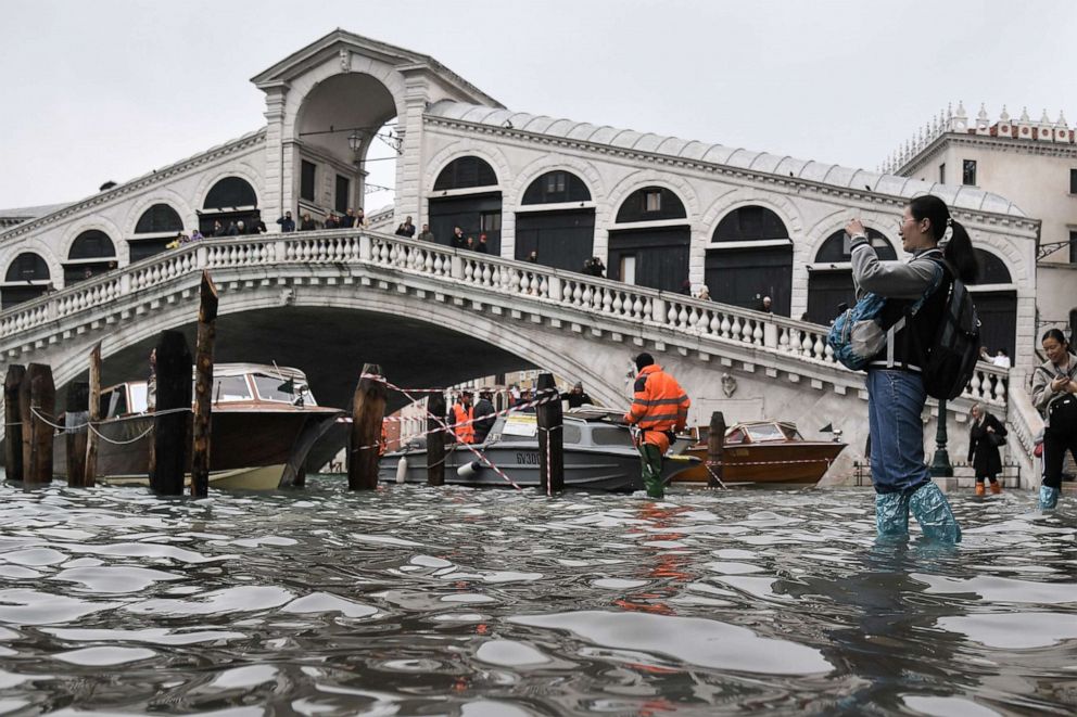 PHOTO: A tourist takes a photo from the flooded embankment by the Rialto bridge, after an exceptional overnight "Alta Acqua" high tide water level, Nov. 13, 2019, in Venice. 