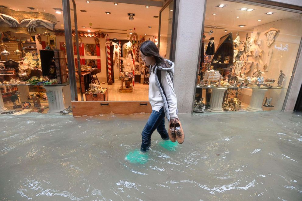 PHOTO: A woman walks in a flooded street of Venice, Italy, Monday, Oct. 29, 2018.