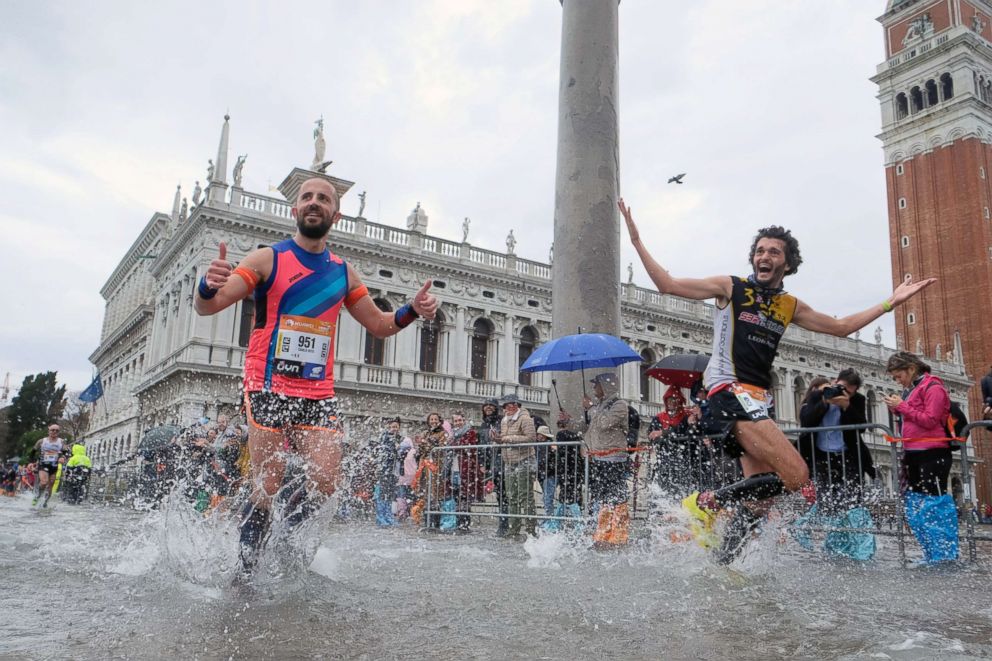 PHOTO: People run in the 33rd Venice Marathon during high tides in Venice, Oct. 28, 2018.