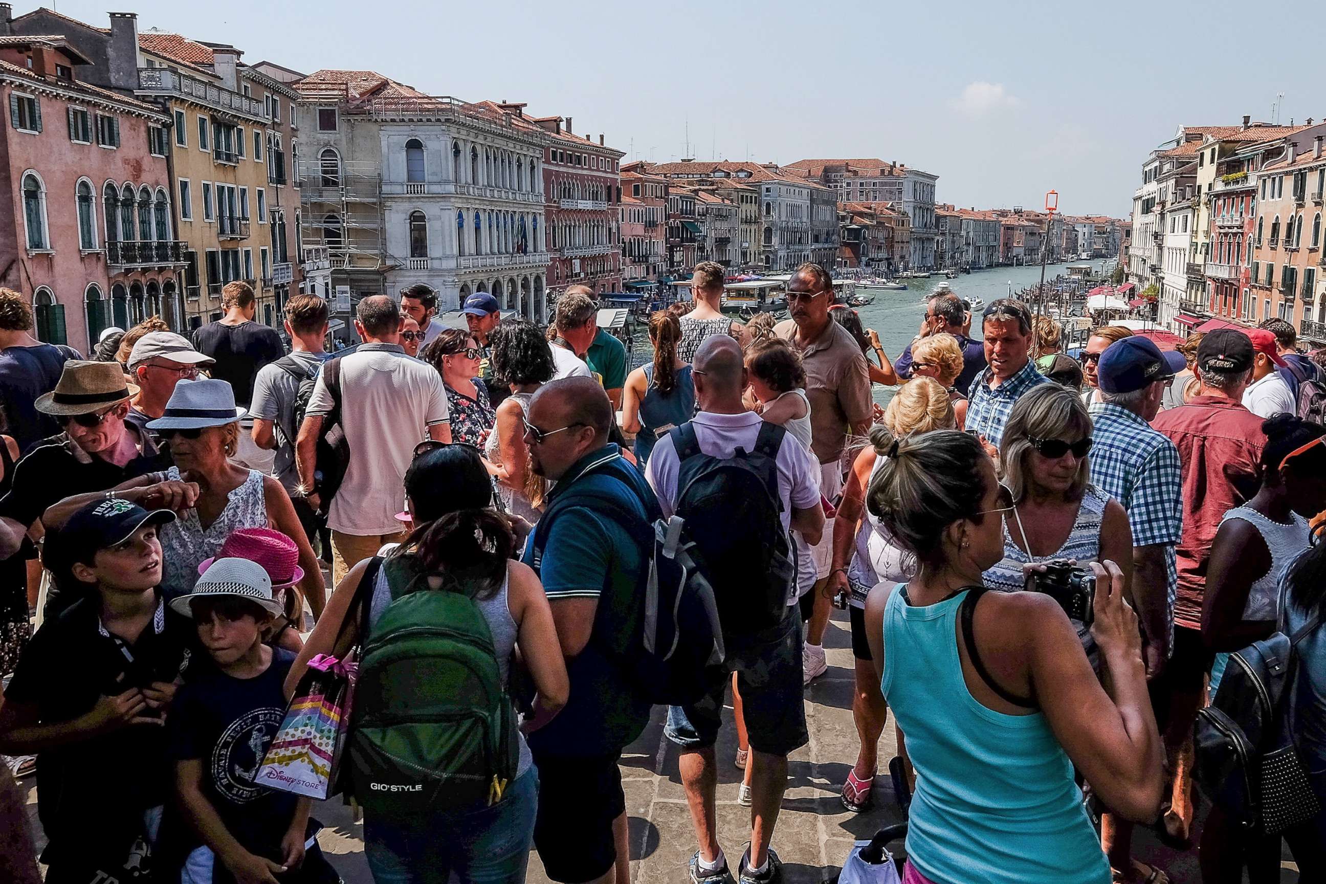 PHOTO: A large crowd of tourists stand on the Rialto bridge, Aug. 1, 2017, in Venice, Italy. 