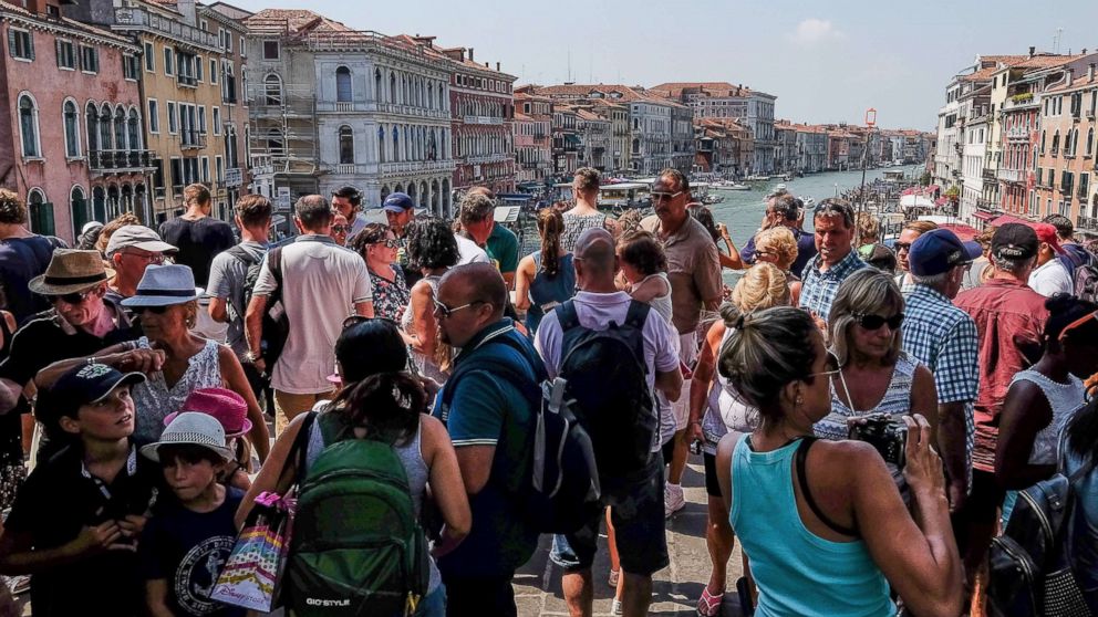 PHOTO: A large crowd of tourists stand on the Rialto bridge, Aug. 1, 2017, in Venice, Italy. 