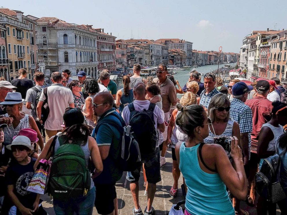 PHOTO: A large crowd of tourists stand on the Rialto bridge, Aug. 1, 2017, in Venice, Italy.