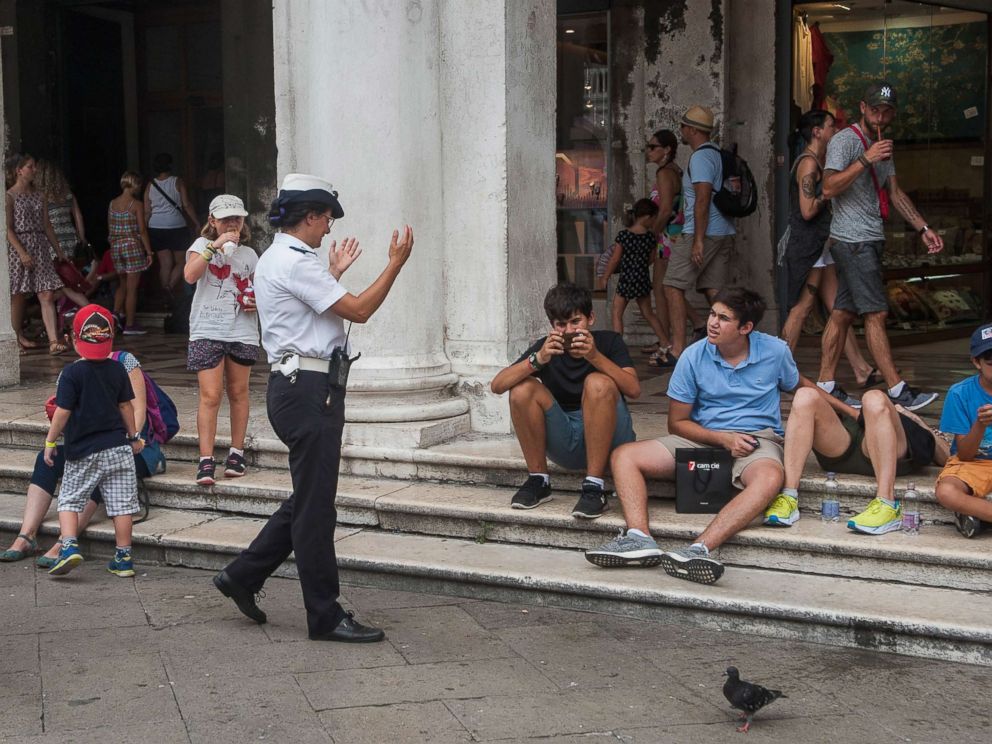 PHOTO: A local police officer tells tourists to move away from Saint Marks Square on Aug. 14, 2017 in Venice, Italy.