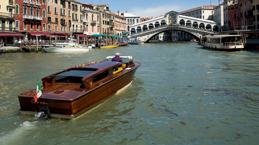 A water taxi navigates the busy Grand Canal heading to the Rialto Bridge, April 13, 2011, in Venice.