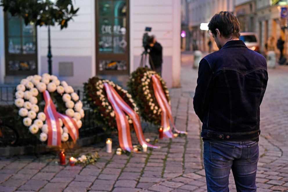 PHOTO: A pedestrian prays at the wreaths laid by the Austrian government at a crime scene in the city center the day after a deadly shooting spree, Nov. 3, 2020, in Vienna, Austria.