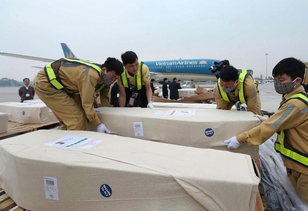 PHOTO: Coffins arrive on the tarmac of the Noi Bai airport on Nov. 27, 2019, in Hanoi, Vietnam. Media in Vietnam say the bodies of 16 of the 39 Vietnamese who died when human traffickers carried them by truck to England been repatriated to their homeland.