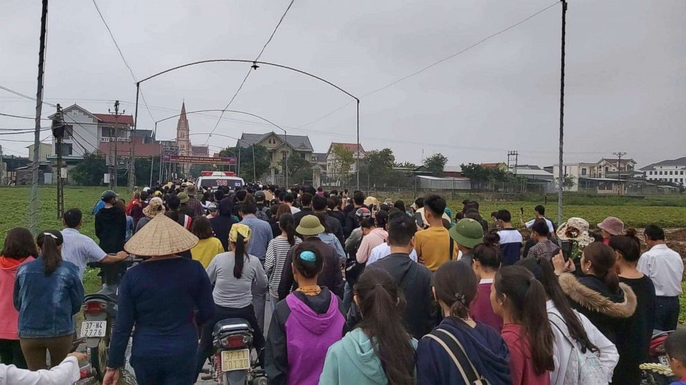 PHOTO: Local villagers follows ambulances carrying the bodies of Nguyen Van Hung and Hoang Van Tiep, two of the 39 people found dead in a truck in England, to their home village,  Dien Chau district, Nghe An province, Vietnam, Nov. 27, 2019.