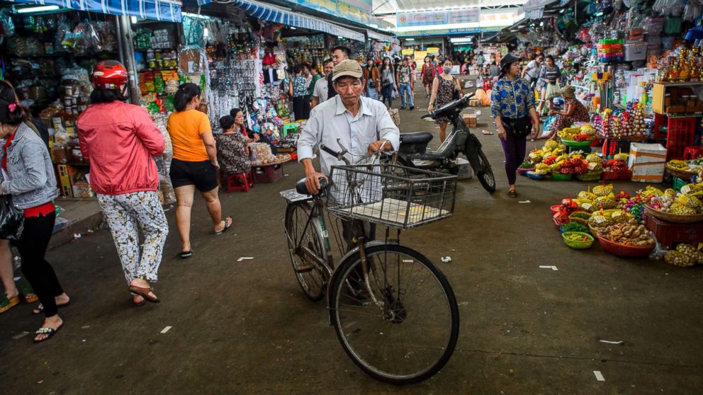 PHOTO: A man walks with his bicycle in the Con Market in the central Vietnamese city of Danang in this Nov. 11, 2017 file photo.