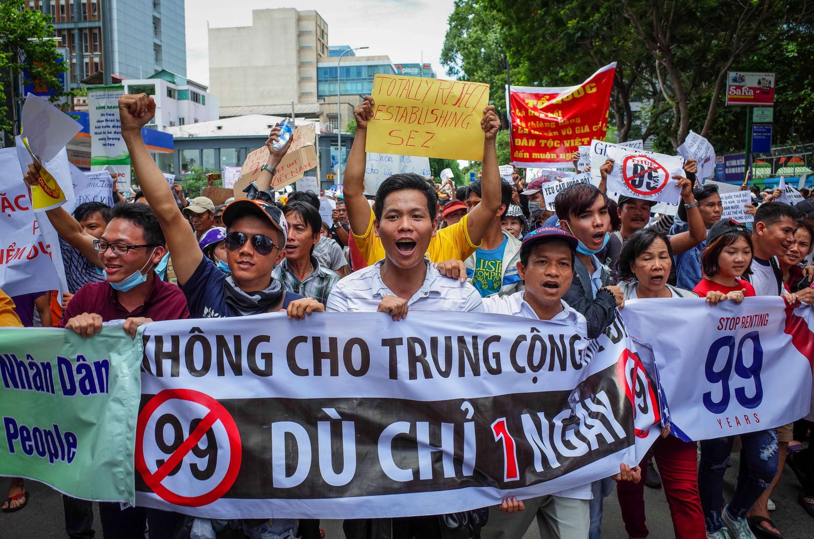 PHOTO: Vietnamese protesters shout slogans against a proposal to grant companies lengthy land leases during a demonstration in Ho Chi Minh City, June 10, 2018.