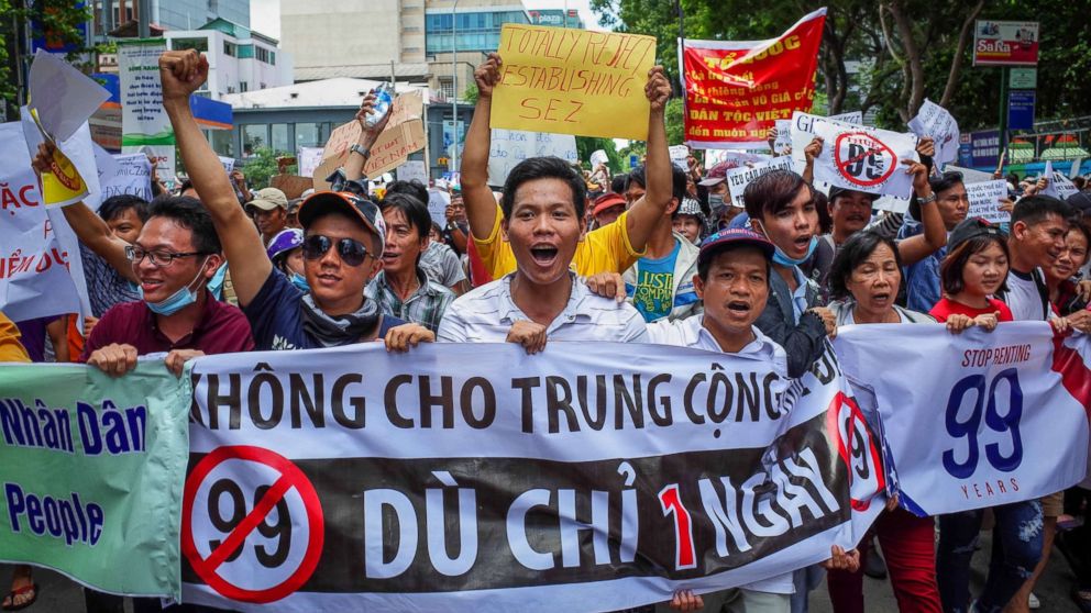 Vietnamese protesters shout slogans against a proposal to grant companies lengthy land leases during a demonstration in Ho Chi Minh City, June 10, 2018.