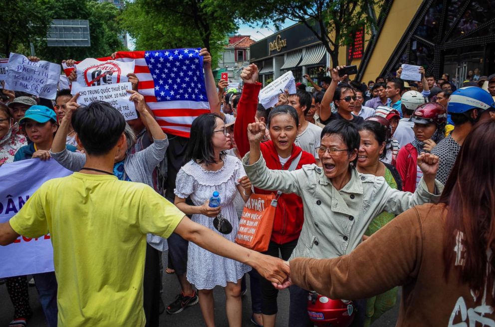 PHOTO: Vietnamese protesters shout slogans against a proposal to grant companies lengthy land leases during a demonstration in Ho Chi Minh City, June 10, 2018.