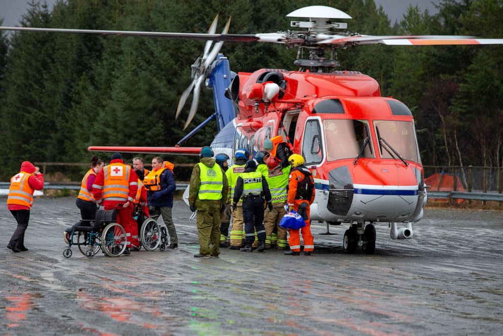 PHOTO: Passengers are helped out of a rescue helicopter after being rescued from cruise ship Viking Sky in Hustadvika, Norway, March 24, 2019. 