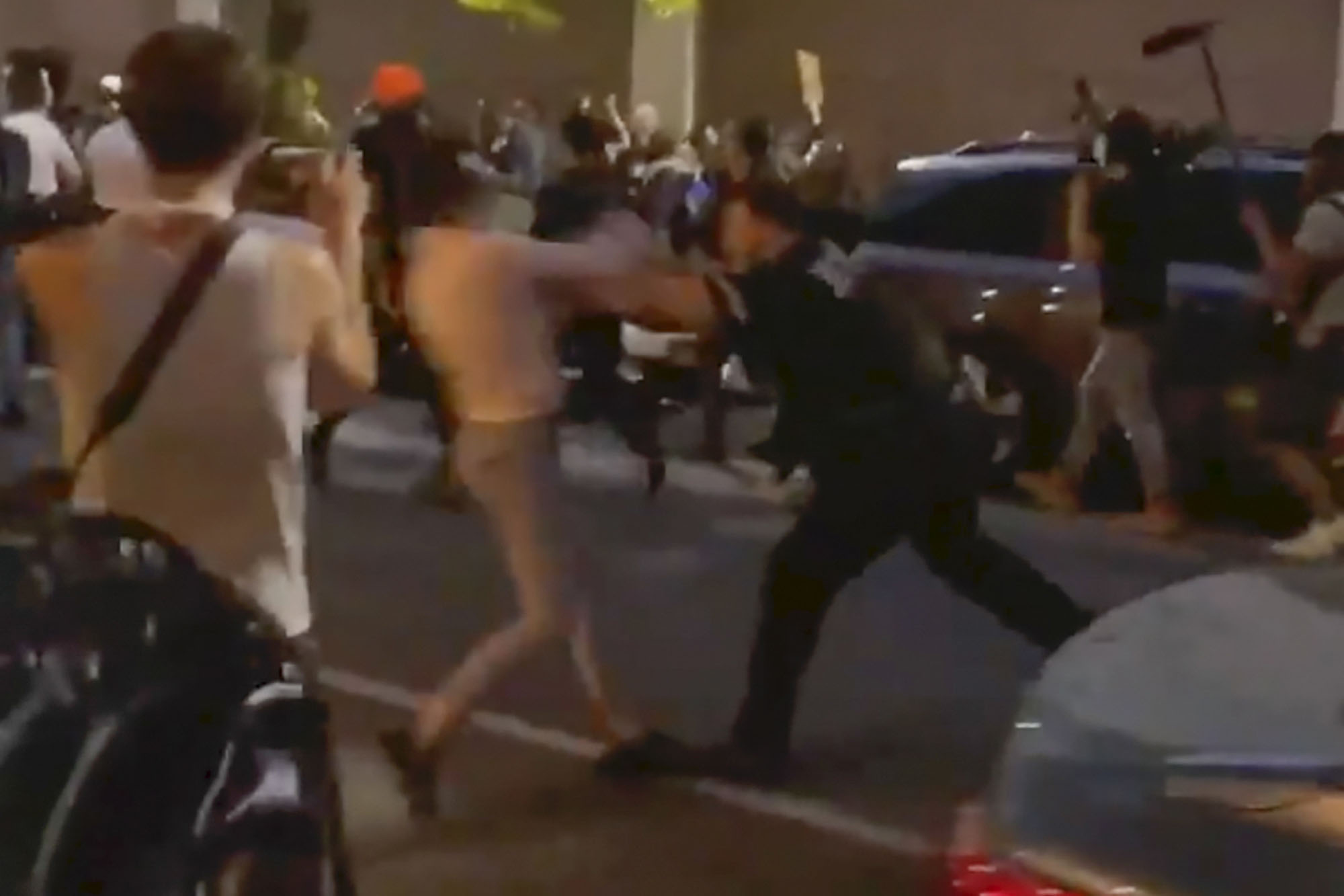 PHOTO: In this May 29, 2020, screen grab taken from video, New York police officer Vincent D'Andraia, right, pushes protester Dounya Zayer during a protest in the Brooklyn borough of New York.