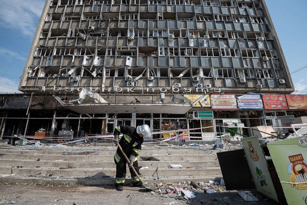PHOTO: A rescuer clears rubble by the heavily damaged office building, July 15, 2022, in Vinnytsia, Ukraine.