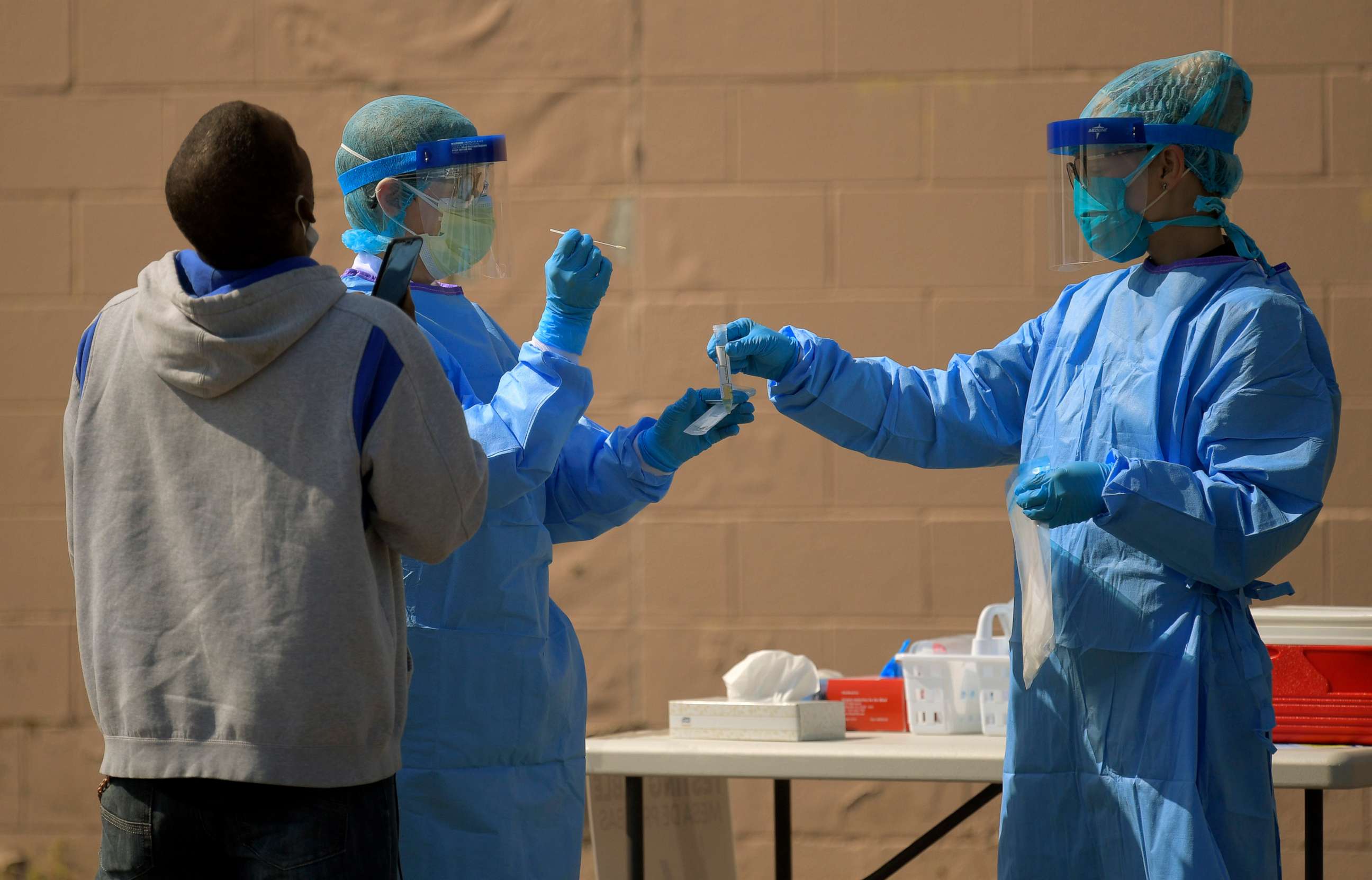 PHOTO: In this April 28, 2020, file photo, a health volunteer prepares to store a swab into a marked test tube that was used to collect a sample at a testing site in Richmond, Va.