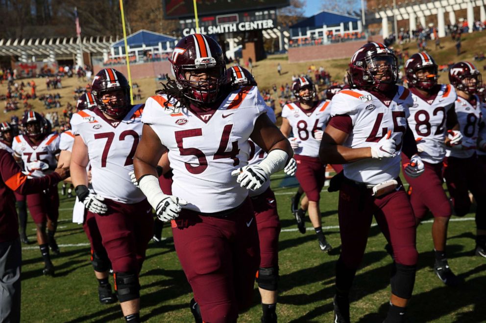 PHOTO: Virginia Tech Hokies runs off the field before the start of a game against the Virginia Cavaliers at Scott Stadium in Charlottesville, Va.