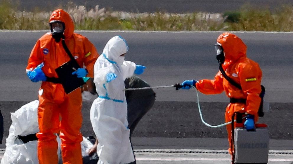 PHOTO: A passenger of the cruise ship MV Hondius, which was affected by a hantavirus outbreak, gets disinfected on the tarmac at Tenerife Sud airport, Canary Islands, Spain, May 10, 2026.