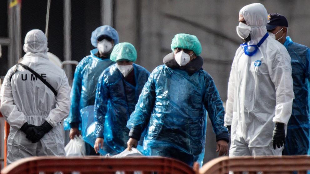 PHOTO: Passengers carry their belongings in plastic bags after being evacuated from the MV Hondius after docking in the Granadilla Port, May 10, 2026 in Tenerife, part of the Canary Islands, Spain. 