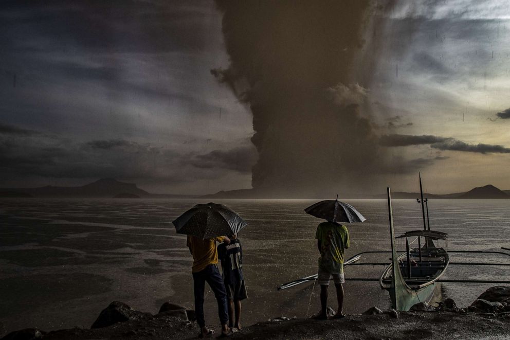 PHOTO: Residents look on as Taal Volcano erupts, Jan. 12, 2020, in Talisay, Philippines.