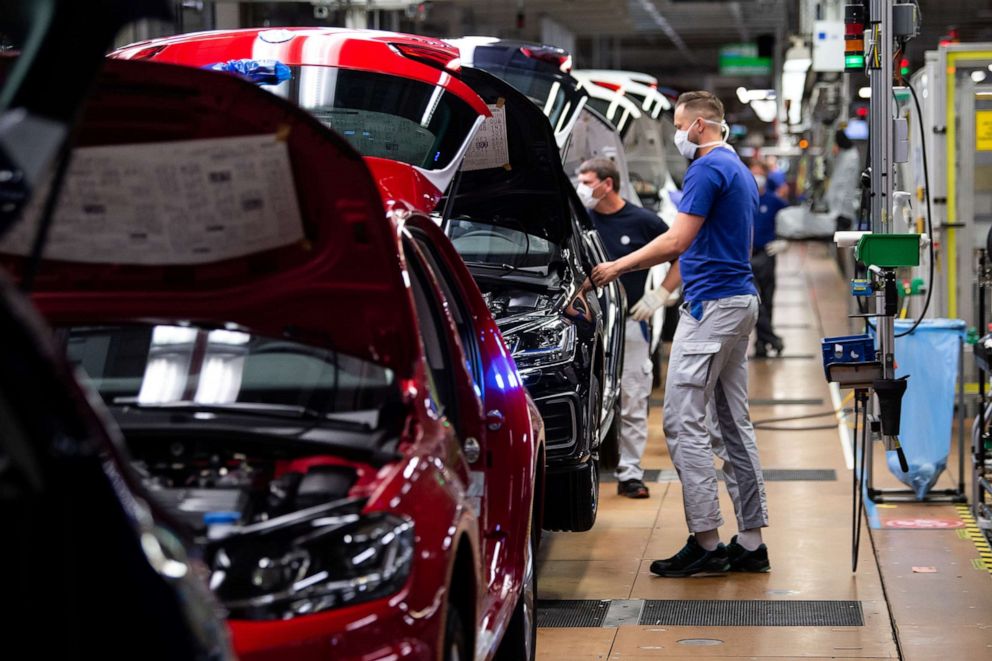 PHOTO: A worker wears a protective mask at the Volkswagen assembly line as the company resumes production at Europe's largest car factory after a coronavirus shutdown in Wolfsburg, Germany, on April 27, 2020.