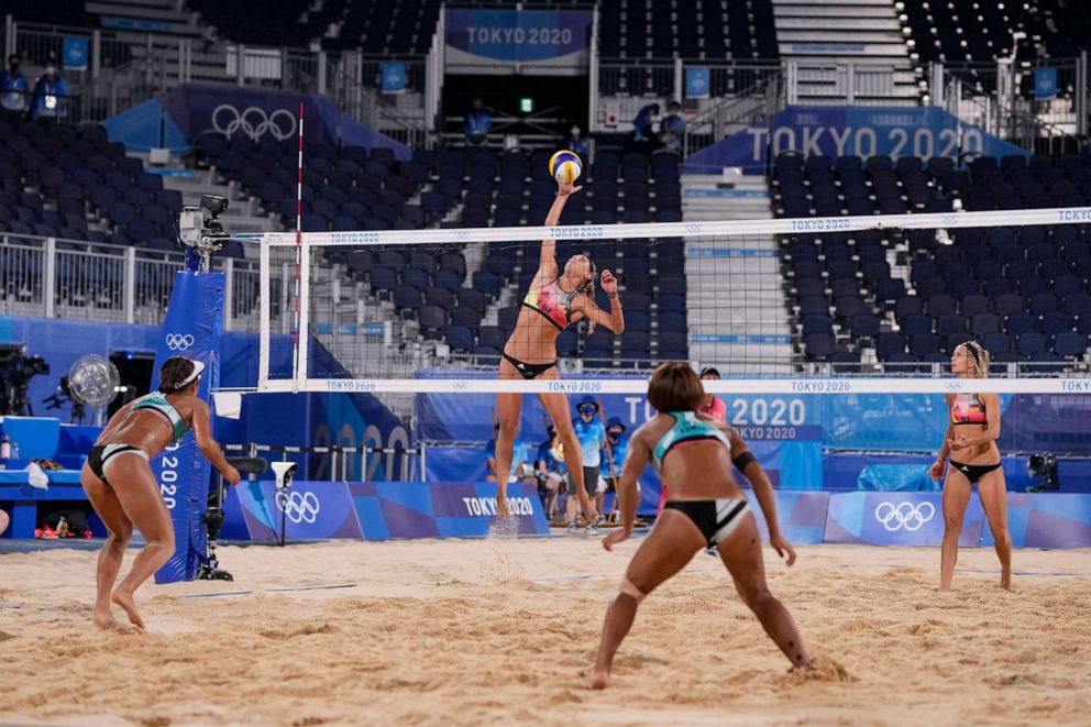 PHOTO: Margareta Kozuch, second from left, of Germany, jumps for a shot as teammate Laura Ludwig looks on while Megumi Murakami, left, of Japan, and teammate Miki Ishii wait for the ball during a women's beach volleyball match at the 2020 Summer Olympics.