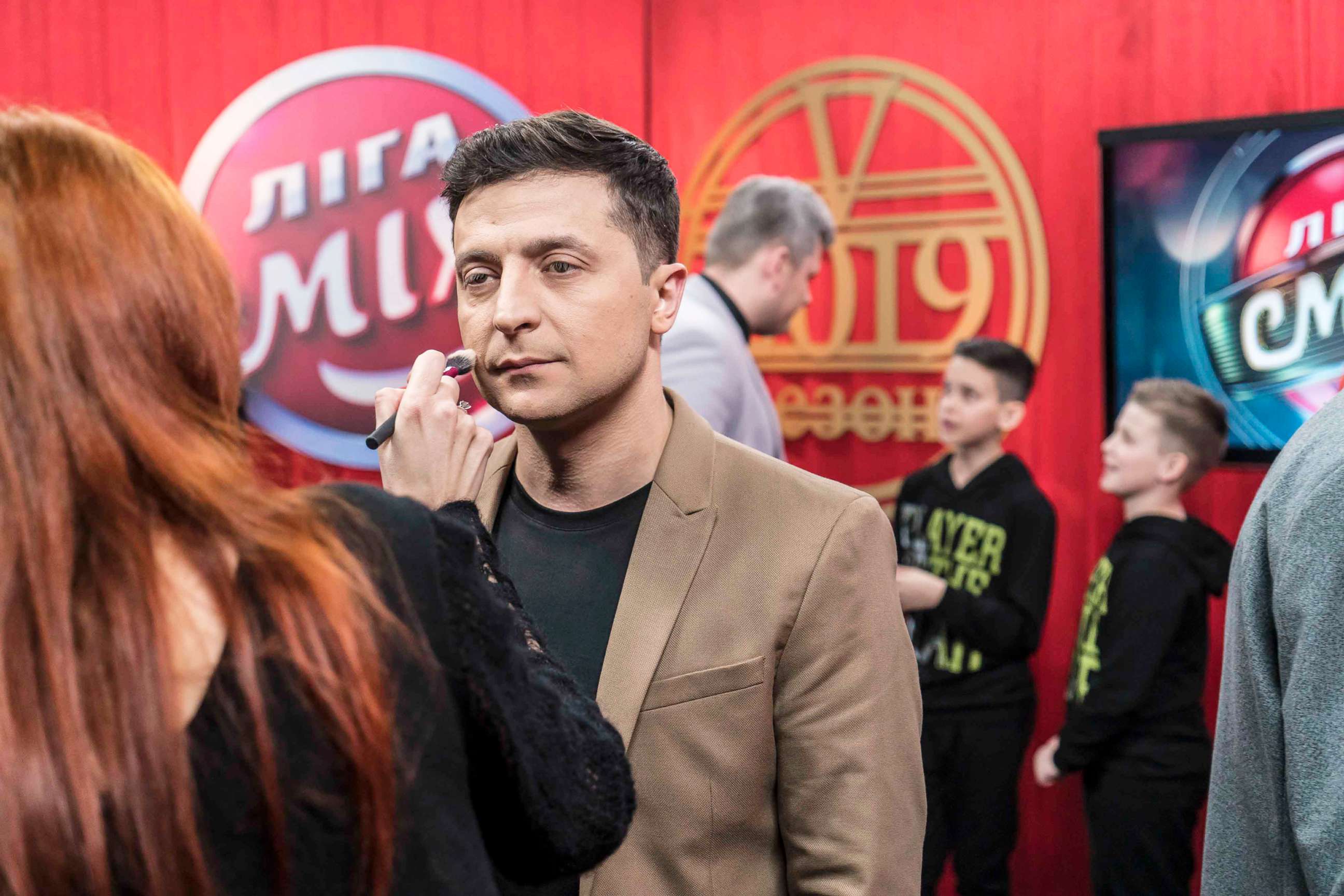 PHOTO: Ukrainian presidential candidate Volodymyr Zelenskiy has makeup applied backstage during the filming of his comedy show Liga Smeha (League of Laughter) on March 19, 2019 in Kiev, Ukraine.