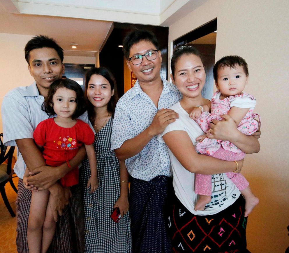 Reuters journalist Wa Lone (3rd R) poses with his wife Pan Ei Mon (2nd R) and daughter along with his colleague Kyaw Soe Oo, L, carrying his daughter and his wife Chit Su Win after being freed from prison in a presidential amnesty in Yangon,May 7, 2019.
