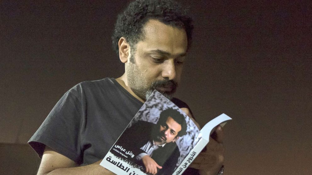 In this June 9, 2017 file photo provided by Roger Anis, prominent activist and blogger Wael Abbas signs a copy of his book, "The theory of leaving the bowl,"?� in Cairo. Egyptian security officials said Abbas, known for documenting police abuse, was detained, Wednesday, May 22, 2018, the latest in a new wave of arrests since elections earlier this year.