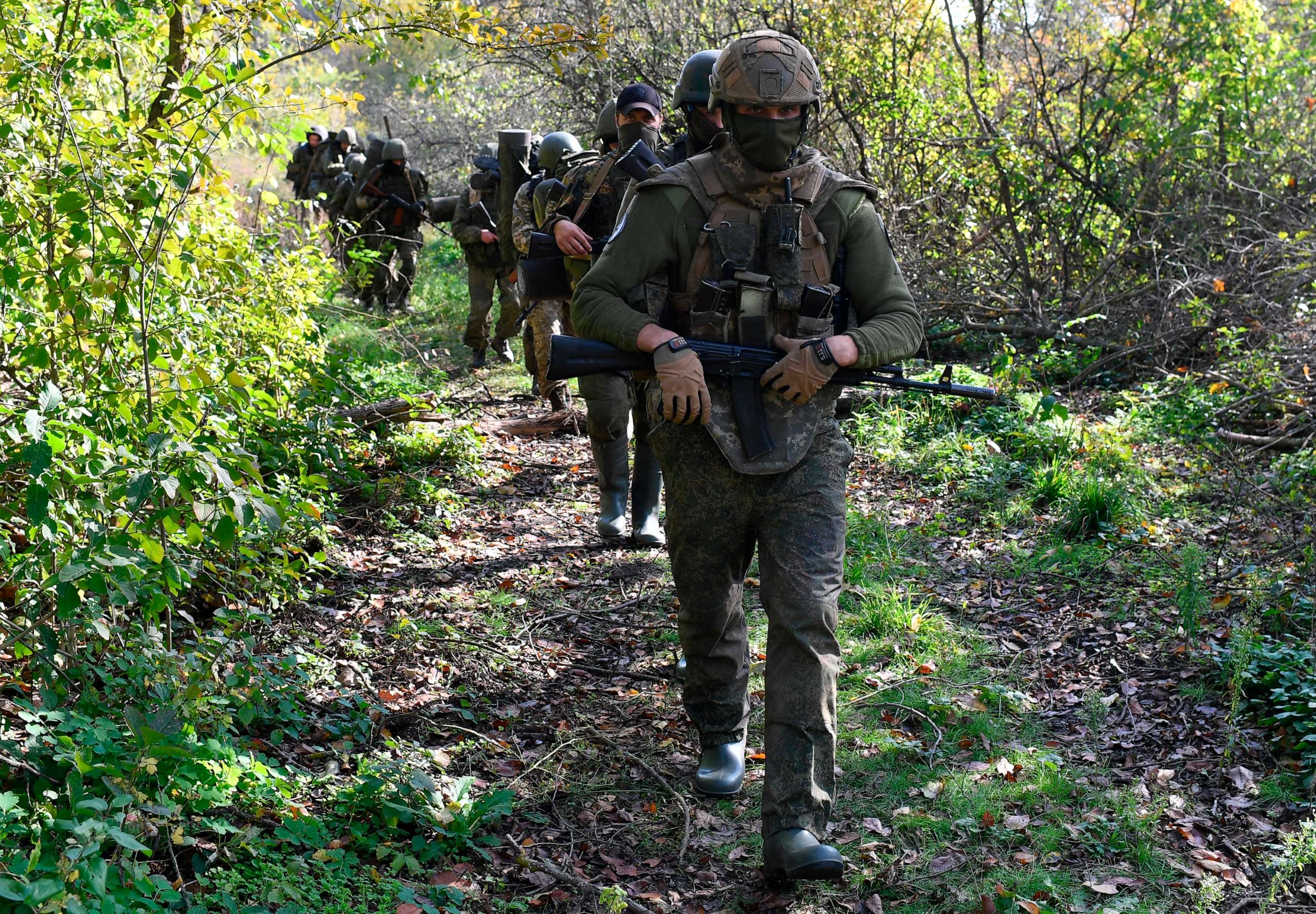 PHOTO: In this Oct. 13, 2022, file photo, service members of Russian private military company Wagner Group bring combat groups to their positions, as Russia's military operation in Ukraine continues, in Luhansk.