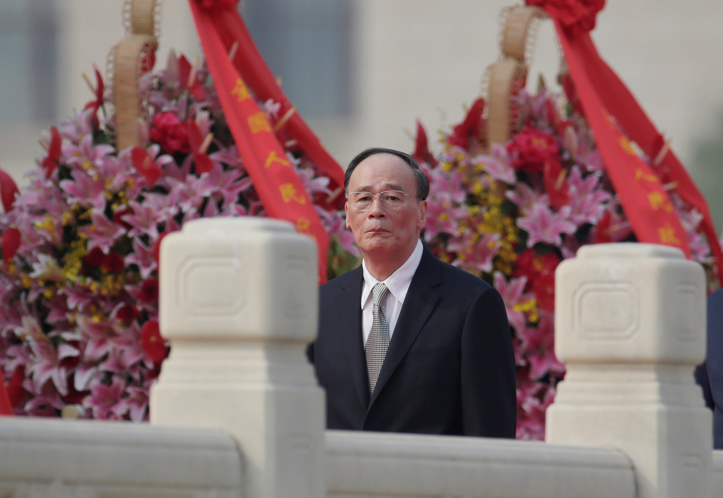 PHOTO: China's Politburo Standing Committee member Wang Qishan, the head of China's anti-corruption watchdog, attends a tribute ceremony in front of the Monument to the People's Heroes at Tiananmen Square, in Beijing, Sept. 30, 2017. 