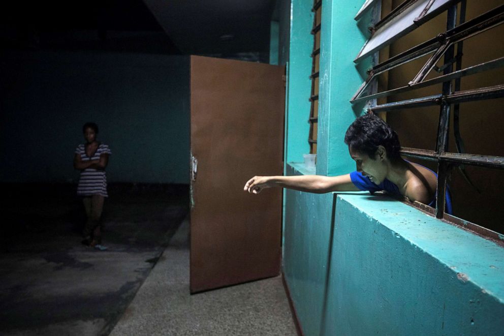 PHOTO: A mental health patient leans out of her room at the Caracas Psychiatric Hospital, in Caracas, Venezuela, July 14, 2019.
