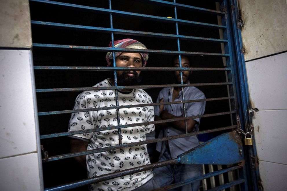 PHOTO: Two mental health patients look behind the bars of their room at the Caracas Psychiatric Hospital, in Caracas, Venezuela, July 14, 2019.