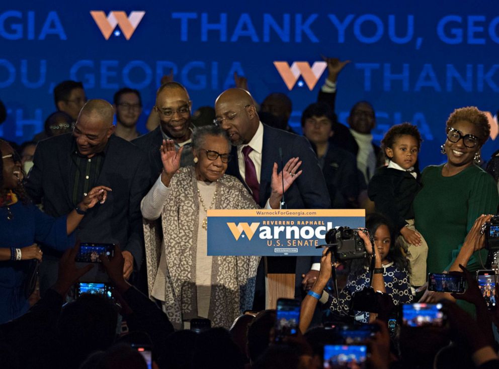 PHOTO: Incumbent Sen. Raphael Warnock celebrates his reelection to the U.S. Senate with his mother, Verlene Warnock, center, siblings and children after delivering his victory speech in Atlanta, Ga., Dec. 6, 2022.