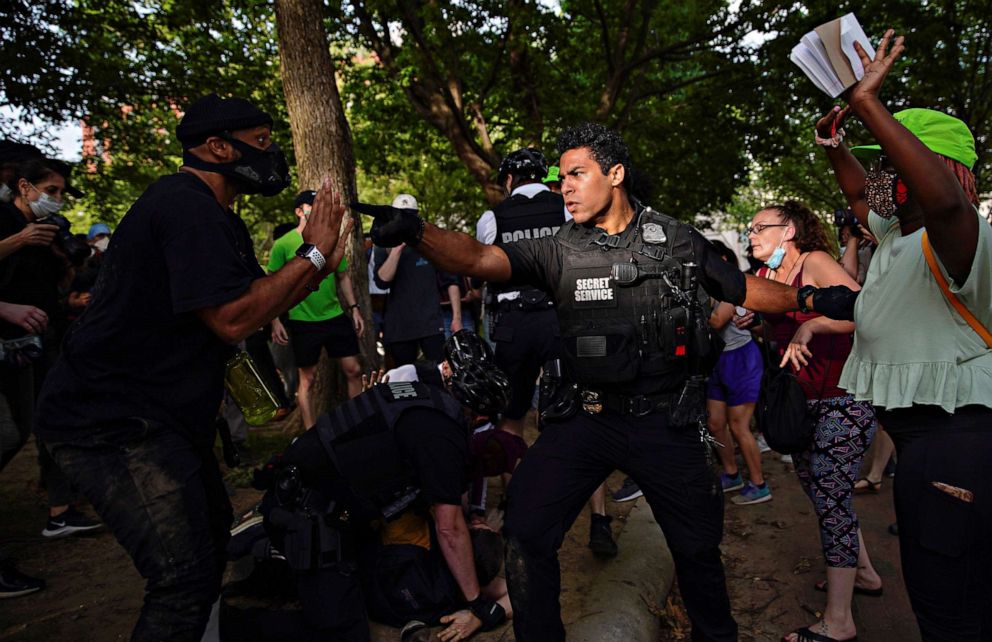 PHOTO: A Secret Service officer orders demonstrators back as other officers detain a protestor during a march on the White House against the death in Minneapolis police custody of George Floyd, in Lafayette Park in Washington, May 29, 2020.