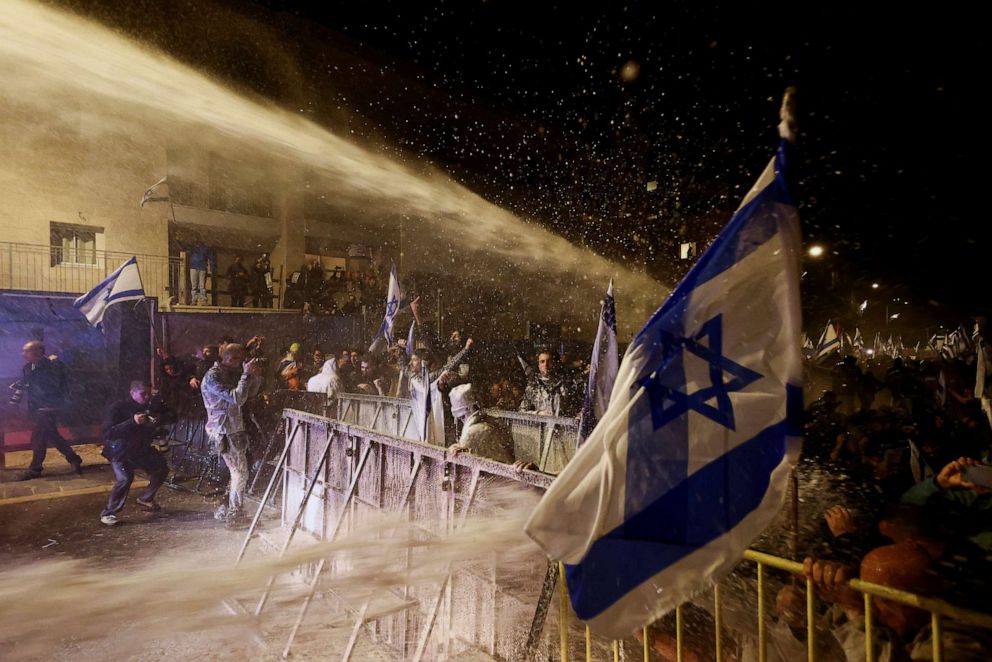 PHOTO: People take part in a demonstration after Israeli Prime Minister Benjamin Netanyahu dismissed the defense minister, in Jerusalem, March 26, 2023.
