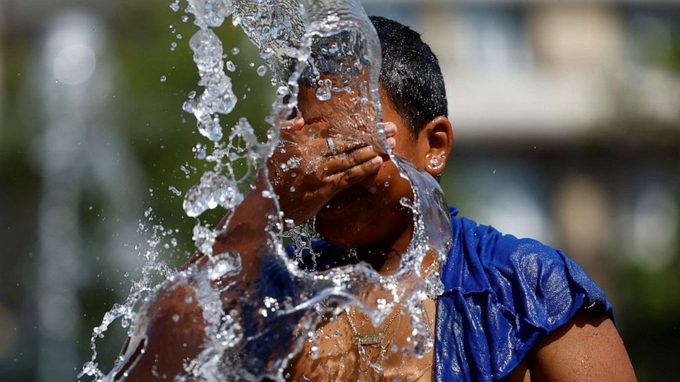 PHOTO: A boy refreshes himself in a fountain during hot weather as a heat wave hits Europe, in Brussels, Belgium, July 19, 2022.