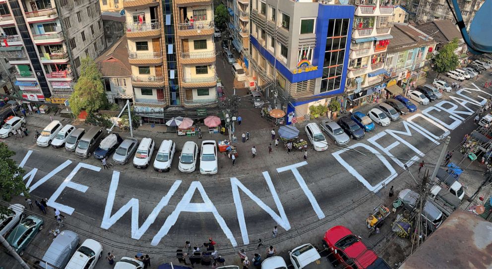 PHOTO: A slogan that reads "We Want Democracy" is written on a street to protest the military junta in Yangon, Myanmar, on Feb. 21, 2021.