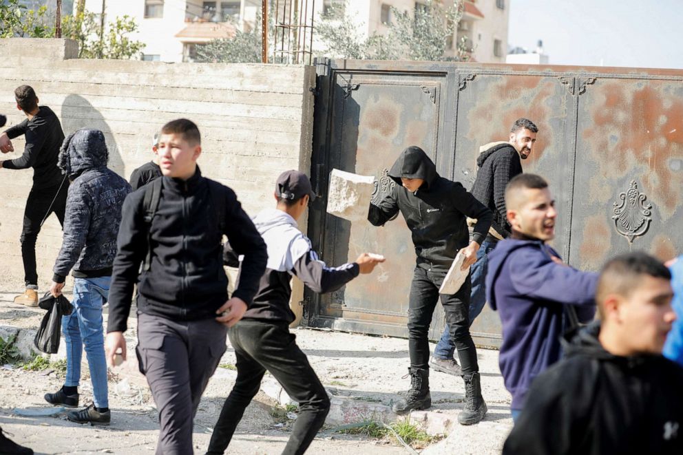 PHOTO: Palestinian stone-throwers gather amid clashes with Israeli troops during a raid in Jenin in the Israeli-occupied West Bank January 26, 2023.