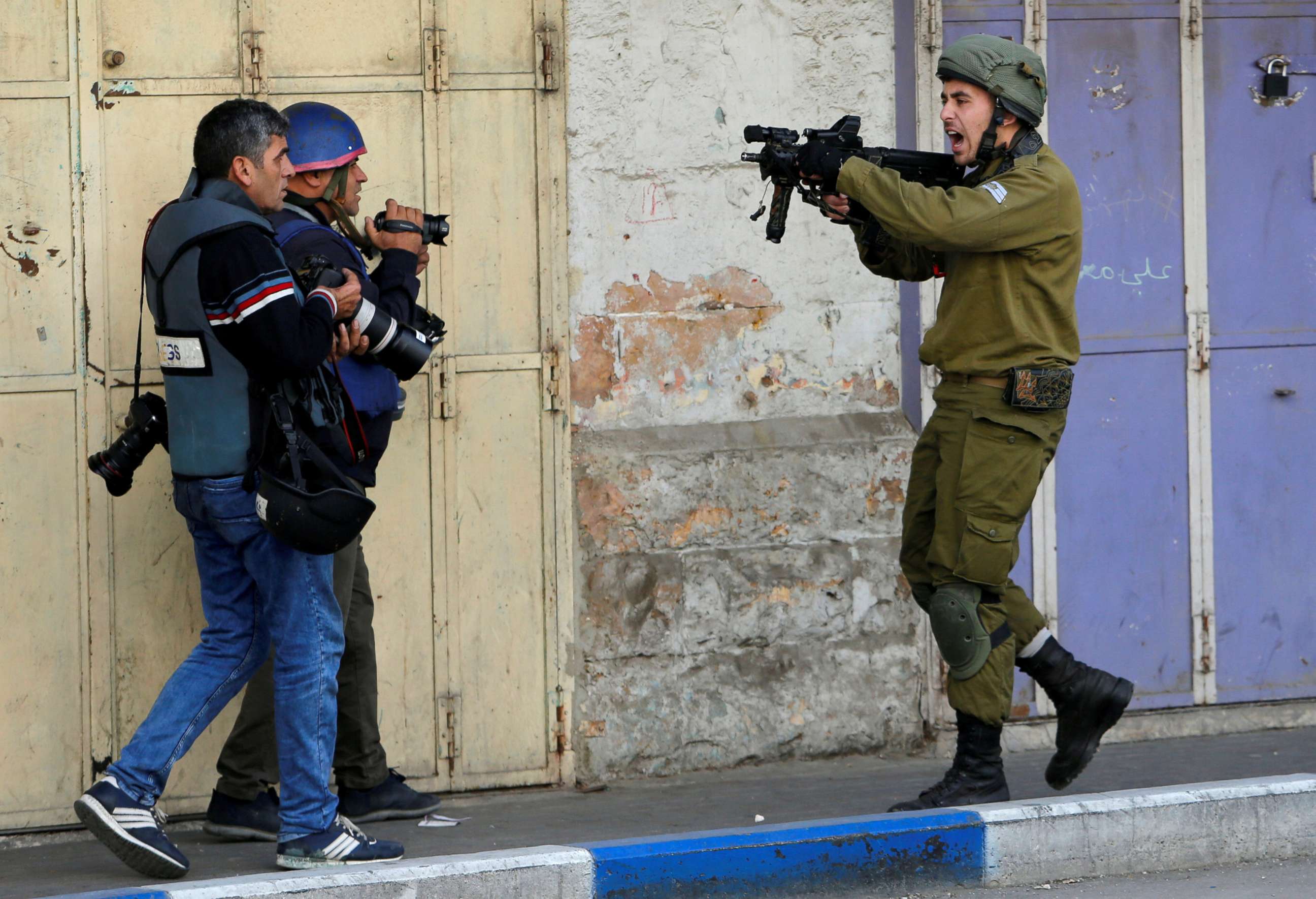 PHOTO: An Israeli soldier shouts as he aims his weapon during clashes with Palestinian demonstrators at a protest against President Donald Trump's decision to recognize Jerusalem as the capital of Israel, in the West Bank city of Hebron, Dec. 15, 2017.