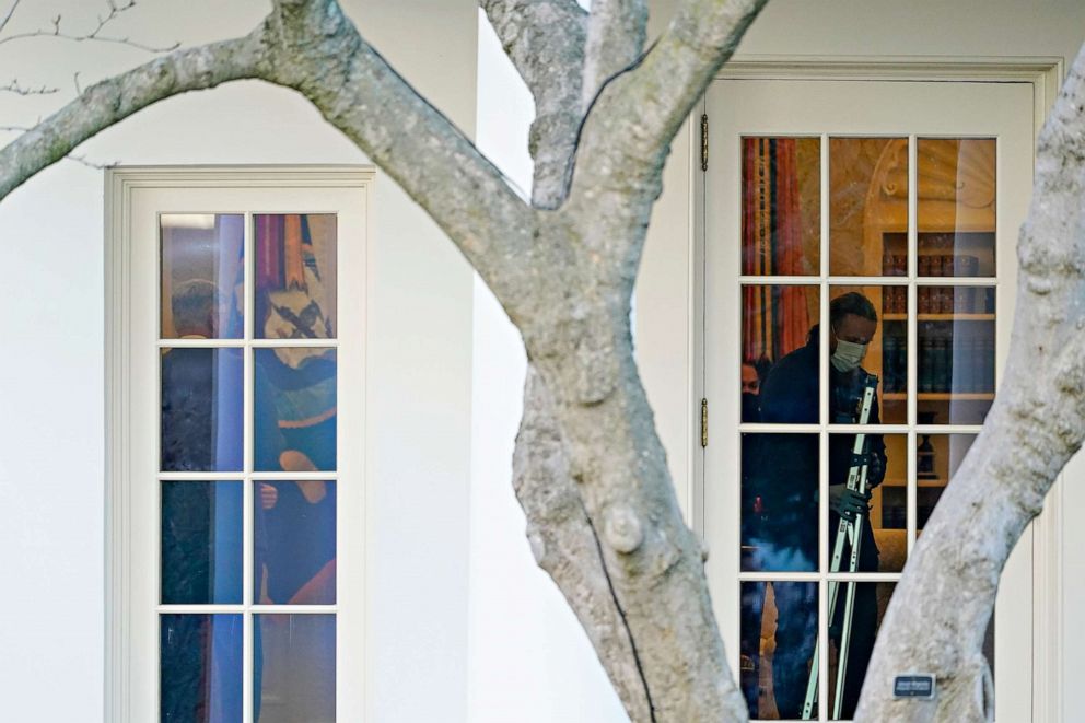 PHOTO: Workers are in the Oval Office as President Donald Trump departs on Marine One on the South Lawn of the White House, Jan. 20, 2021, in Washington.