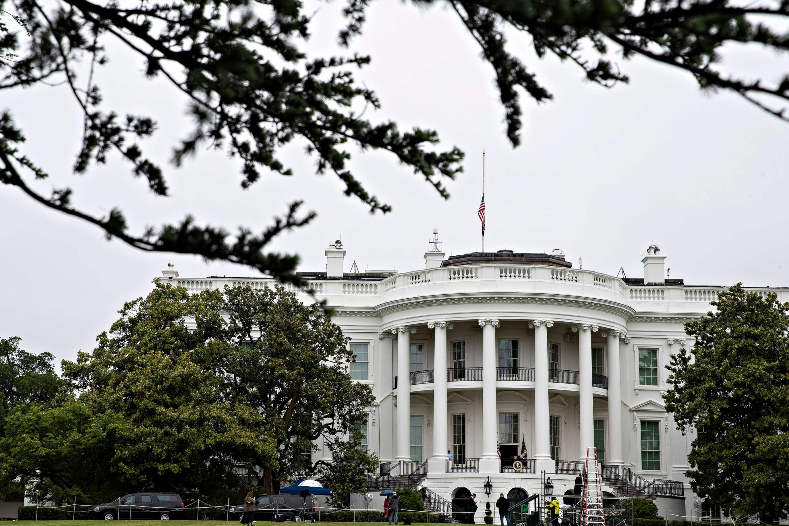 PHOTO: The flag on the roof of the White House flies at half-staff by order of President Donald Trump, "for every life lost to the coronavirus pandemic," May 22, 2020, in Washington.