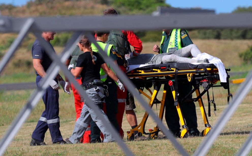 PHOTO: Emergency services attend to an injured person arriving at the airfield on White Island, New Zealand, after the volcanic eruption on Dec. 9, 2019.
